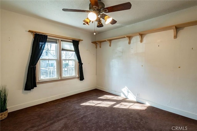 carpeted spare room featuring ceiling fan and a textured ceiling