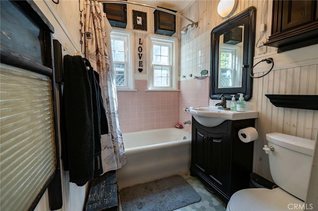 full bathroom with vanity, shower / tub combo with curtain, and toilet