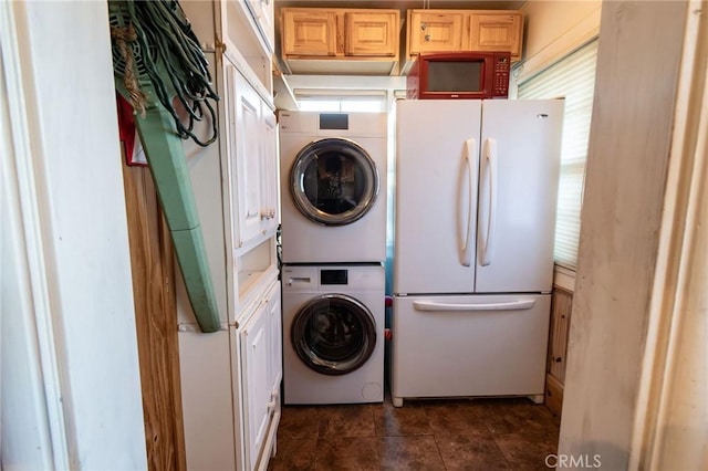 laundry area with stacked washer / drying machine