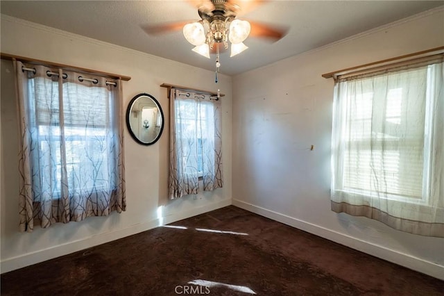 carpeted empty room with ornamental molding and ceiling fan