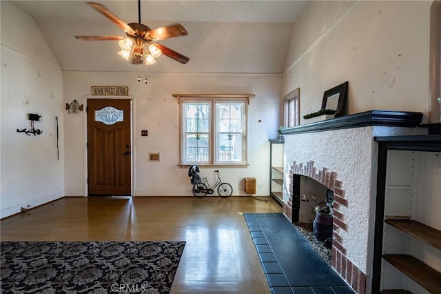 entrance foyer with lofted ceiling, wood-type flooring, and ceiling fan