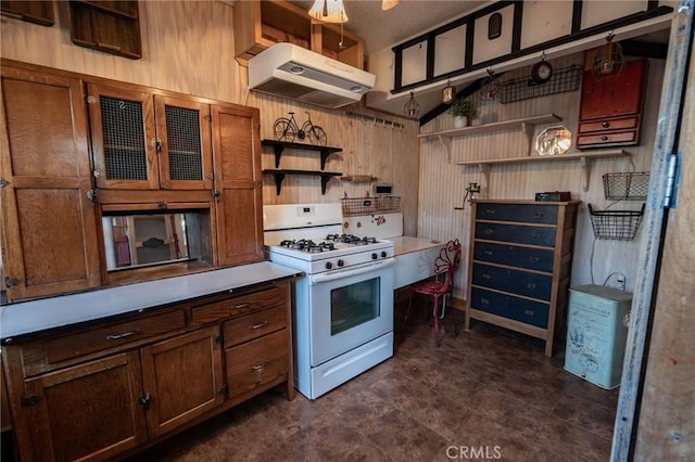 kitchen with decorative light fixtures and white range with gas stovetop