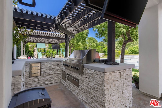 view of patio / terrace featuring a pergola, grilling area, and an outdoor kitchen