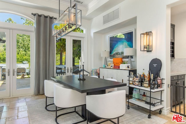 dining room with french doors and crown molding