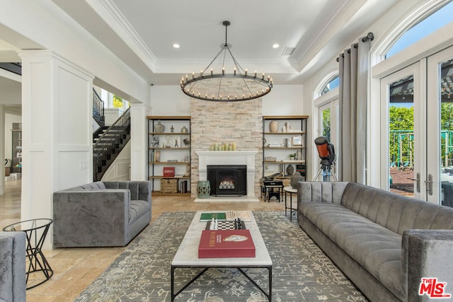 living room featuring crown molding, a raised ceiling, and french doors