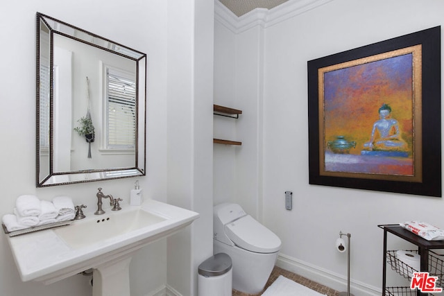 bathroom featuring sink and toilet