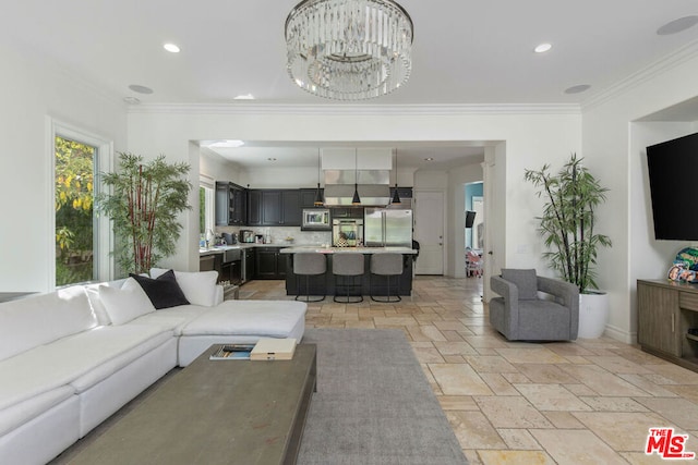 living room featuring crown molding and a chandelier