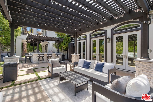 view of patio / terrace featuring french doors, an outdoor hangout area, exterior bar, and a pergola