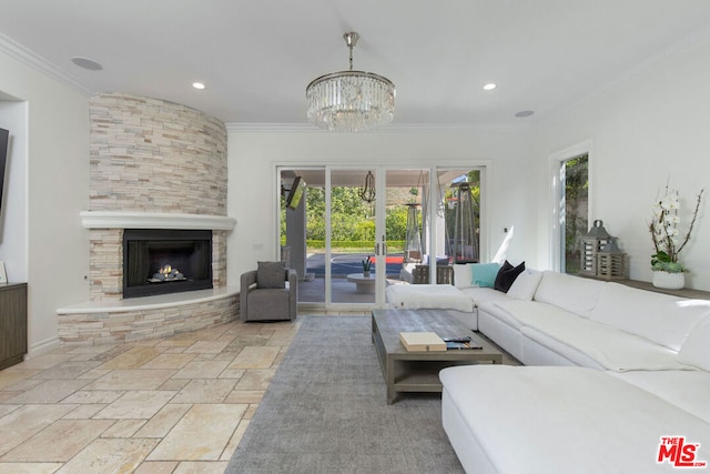 living room with crown molding, a fireplace, a chandelier, and french doors