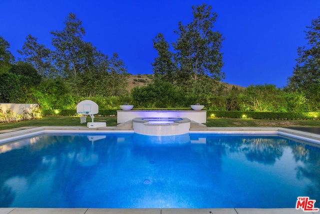 view of swimming pool with an in ground hot tub