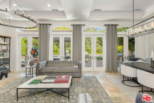 sunroom featuring french doors and a raised ceiling