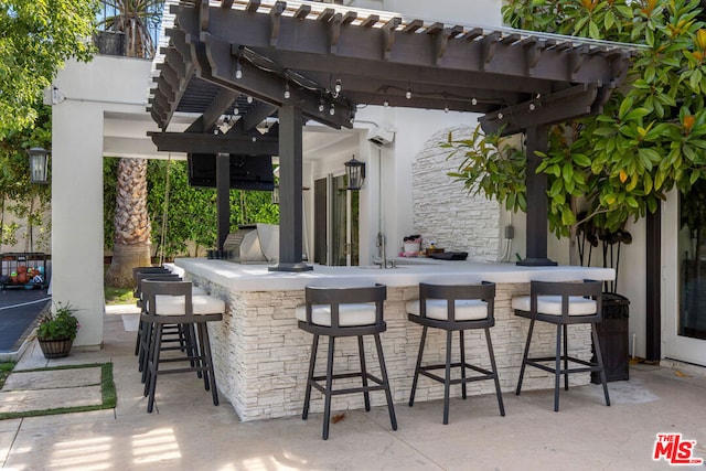 view of patio / terrace with a bar and a pergola