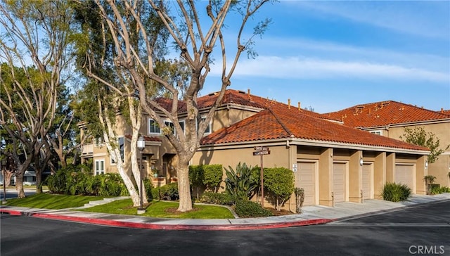 mediterranean / spanish house with a garage