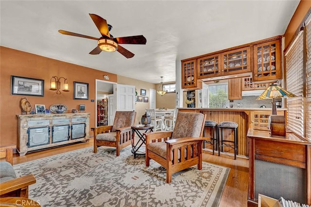 living room with wood-type flooring and ceiling fan