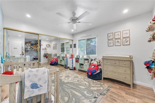 playroom featuring ceiling fan and light hardwood / wood-style flooring