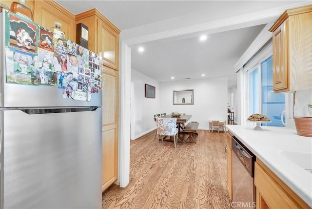 kitchen featuring stainless steel appliances, light brown cabinetry, and light hardwood / wood-style flooring