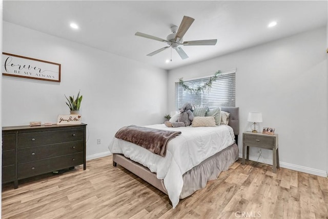 bedroom with ceiling fan and light hardwood / wood-style floors