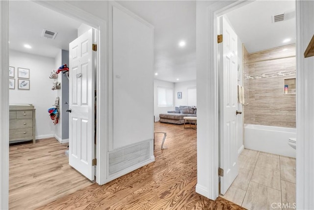 corridor with light hardwood / wood-style floors