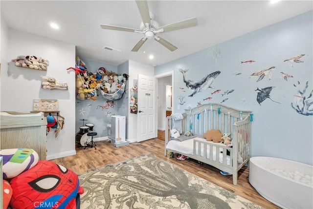 bedroom with ceiling fan and light hardwood / wood-style floors