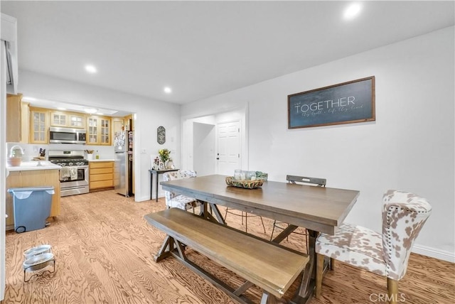 dining area with sink and light hardwood / wood-style flooring