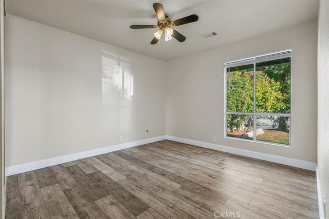 empty room with ceiling fan and light wood-type flooring