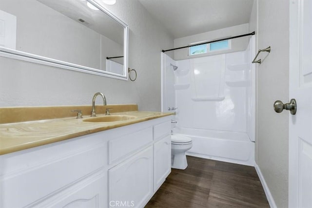 full bathroom with vanity, wood-type flooring, shower / bathtub combination, and toilet