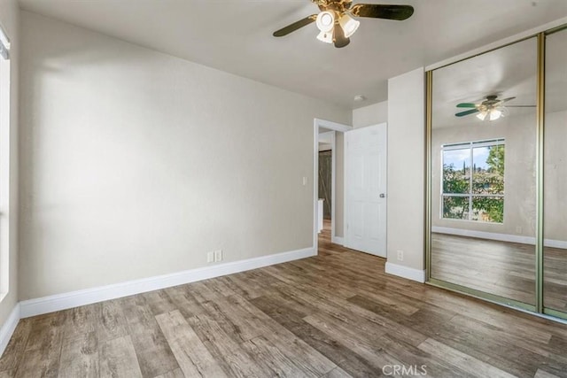 interior space featuring hardwood / wood-style flooring, a closet, and ceiling fan