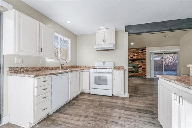 kitchen featuring sink, white appliances, hardwood / wood-style floors, and white cabinets