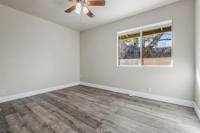 empty room with hardwood / wood-style flooring and ceiling fan