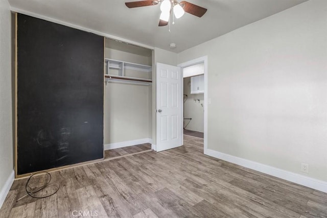 unfurnished bedroom featuring light hardwood / wood-style flooring, a closet, and ceiling fan