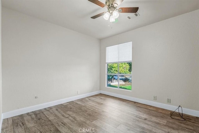 empty room with hardwood / wood-style flooring and ceiling fan