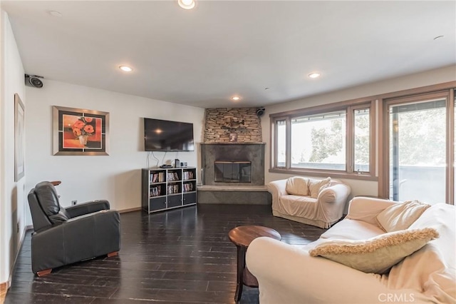 living room with dark hardwood / wood-style floors and a fireplace