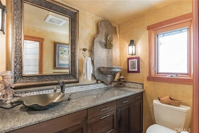 bathroom featuring vanity and toilet