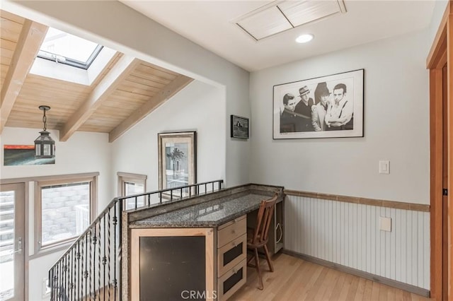 interior space with light hardwood / wood-style flooring, wooden ceiling, and vaulted ceiling with skylight