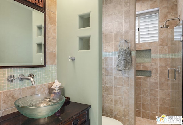 bathroom with vanity, backsplash, and walk in shower