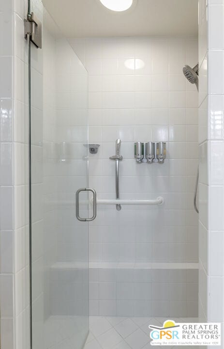 bathroom featuring a shower with door