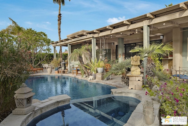 view of swimming pool with a patio and an in ground hot tub