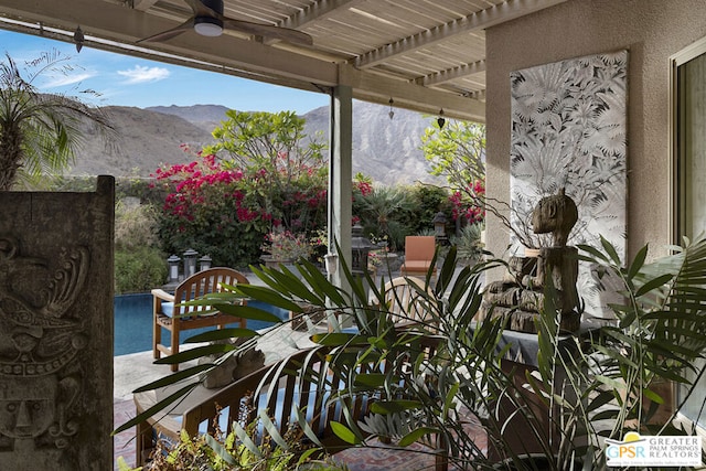 view of patio / terrace with a mountain view and a pergola