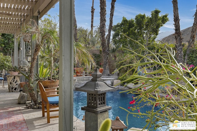 view of pool with a pergola and a water and mountain view