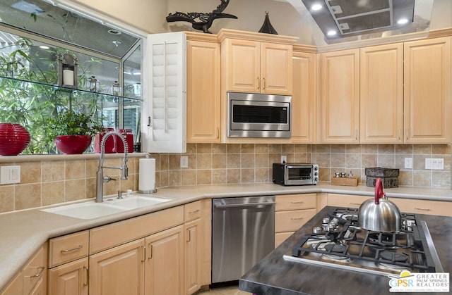 kitchen with sink, light brown cabinets, and appliances with stainless steel finishes