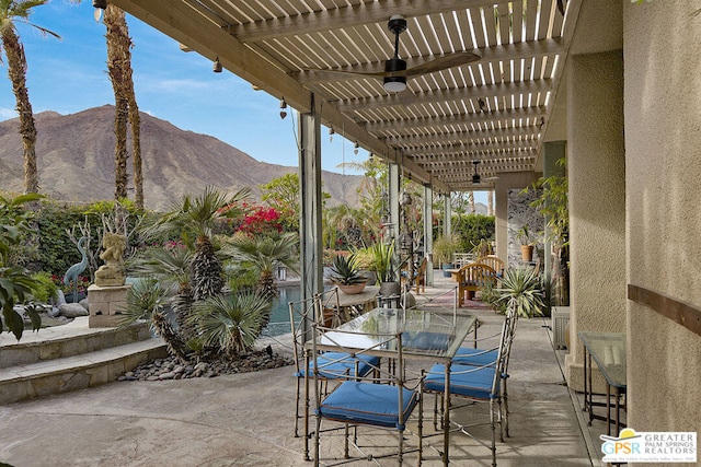 view of patio / terrace with a mountain view and a pergola