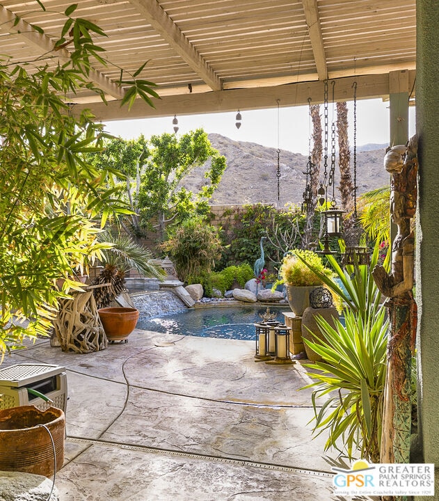 view of patio / terrace with a mountain view and a pergola