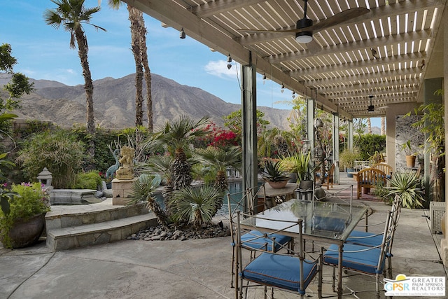 view of patio / terrace with a mountain view and a pergola