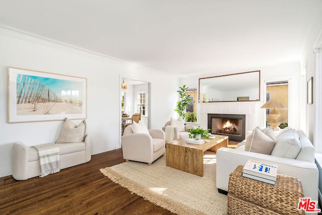 living room with crown molding and hardwood / wood-style floors