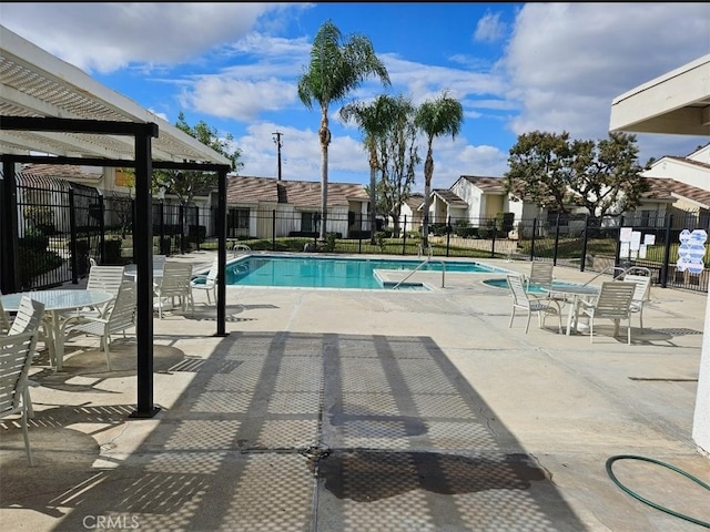 view of swimming pool featuring a patio and a pergola