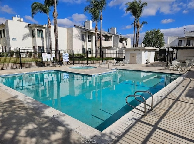 view of pool featuring a patio area and a community hot tub