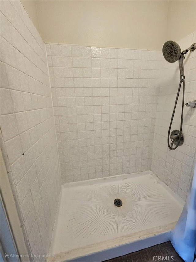 bathroom with a tile shower