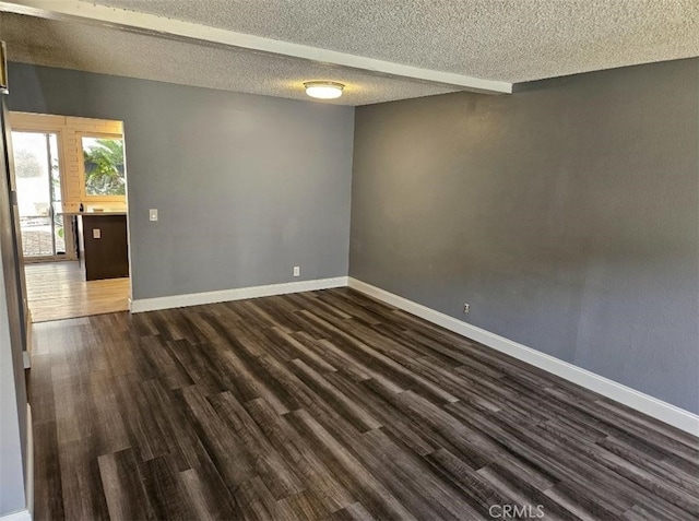 unfurnished room with dark hardwood / wood-style floors and a textured ceiling