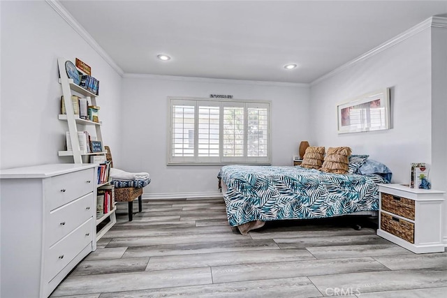 bedroom with crown molding and light hardwood / wood-style floors