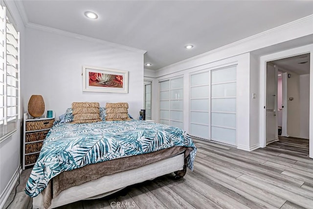 bedroom featuring crown molding and light hardwood / wood-style flooring